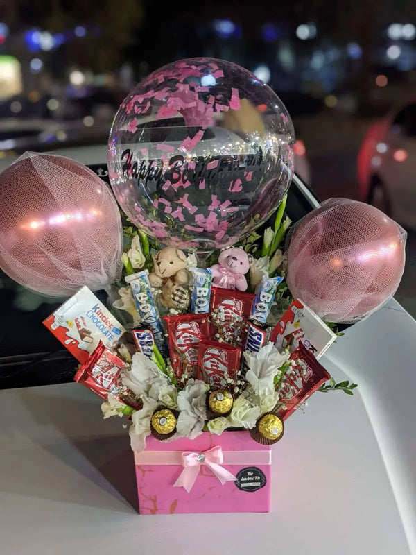 Pink newborn baby girl gift box with an It’s a Girl balloon and assorted premium chocolates