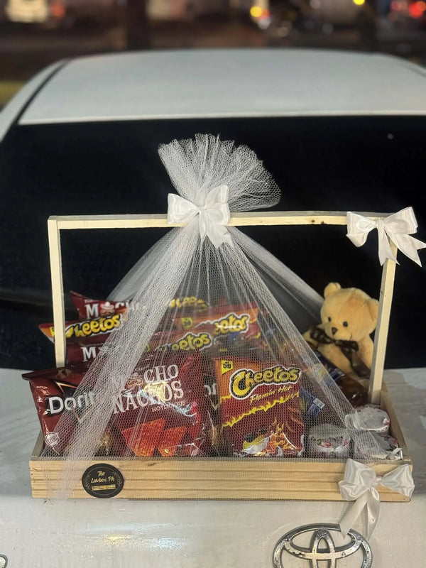 Wooden snack basket with small teddy and scented candles for gift delivery in Islamabad