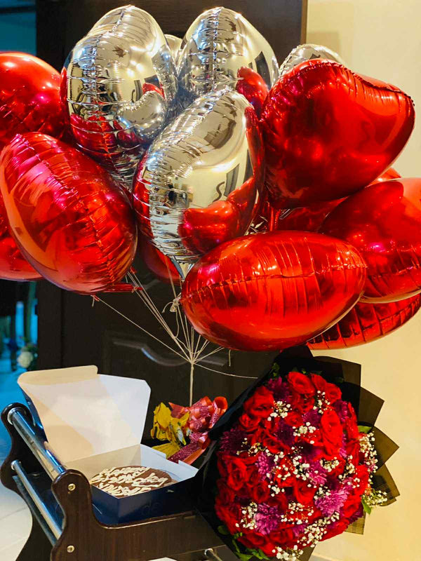 Oversized red rose bouquet with foil balloons and chocolate cake luxury gift