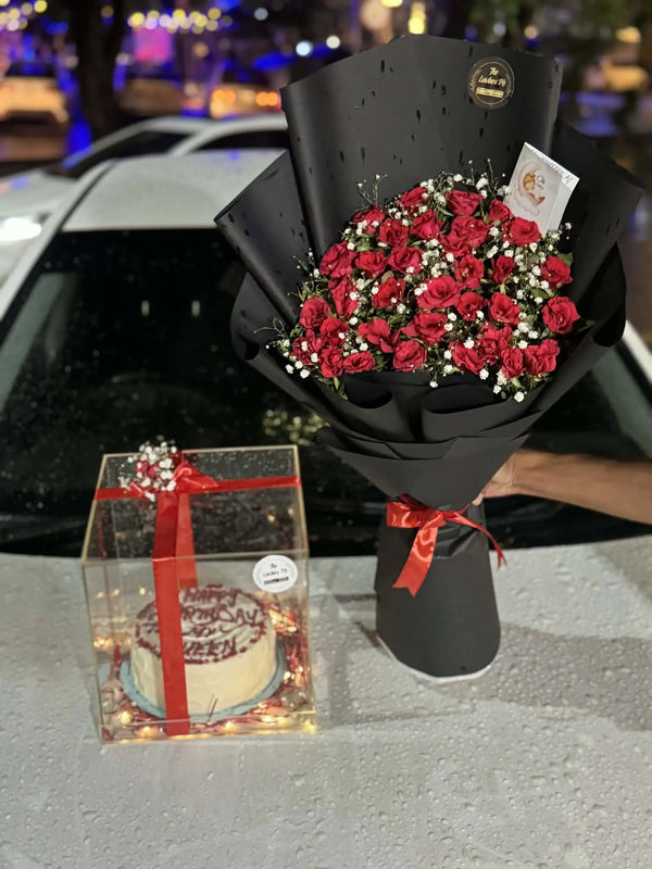 Clear acrylic box with celebration cake and fresh flower bouquet for flower delivery Islamabad