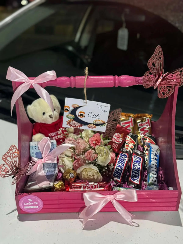 Pink Eid gift basket with fresh flowers, mixed chocolates and PKR 5,000 Eidi