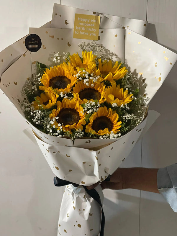 Fresh sunflower bouquet wrapped with an Eid Mubarak tag for delivery in Islamabad