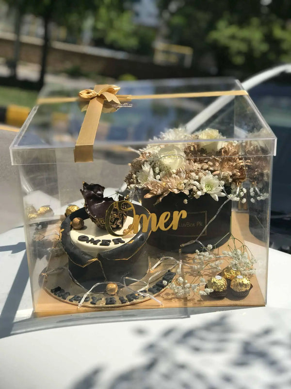 Luxury acrylic gift box with customized cake, Ferrero Rocher chocolates and fresh flowers in Islamabad Pakistan