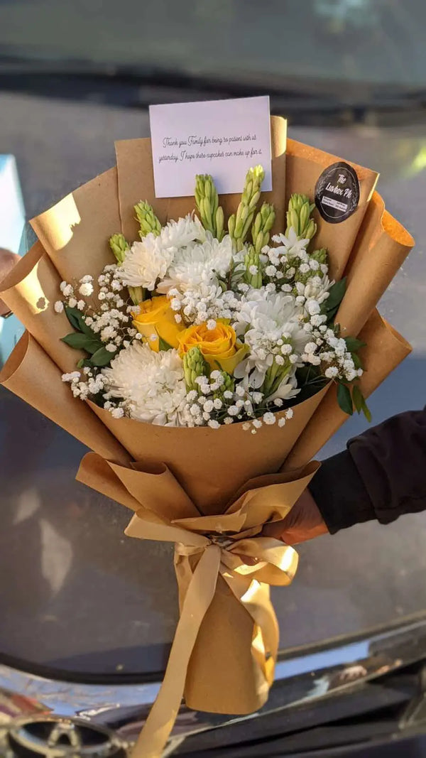 Cheerful seasonal flower bouquet wrapped as a thoughtful Get Well Soon gift