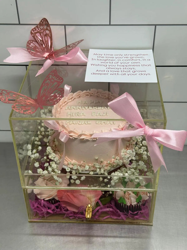 Luxe acrylic anniversary gift box with pink customized cake, cupcakes and macarons