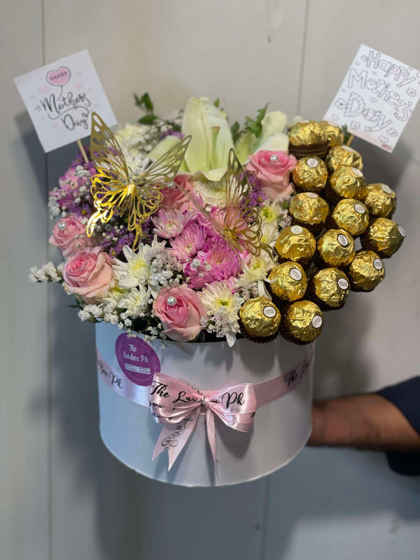 Elegant Mother’s Day gift box featuring fresh flowers and assorted premium chocolates