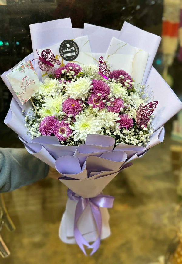 Purple chrysanthemum flower bouquet with elegant wrapping for flower delivery in Islamabad