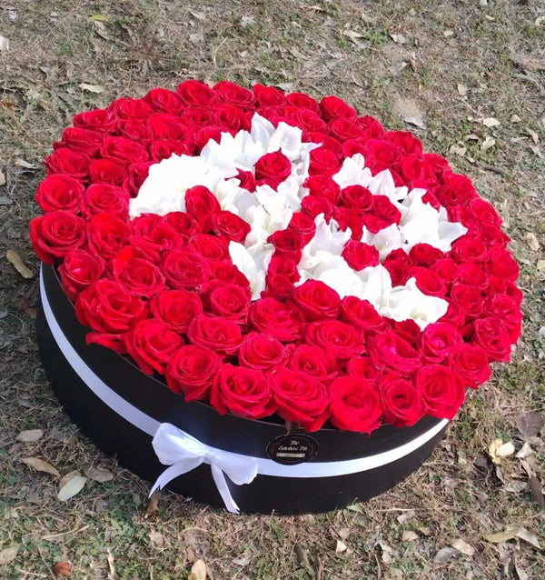 100 red roses flower box with custom white chrysanthemum lettering in Islamabad Pakistan
