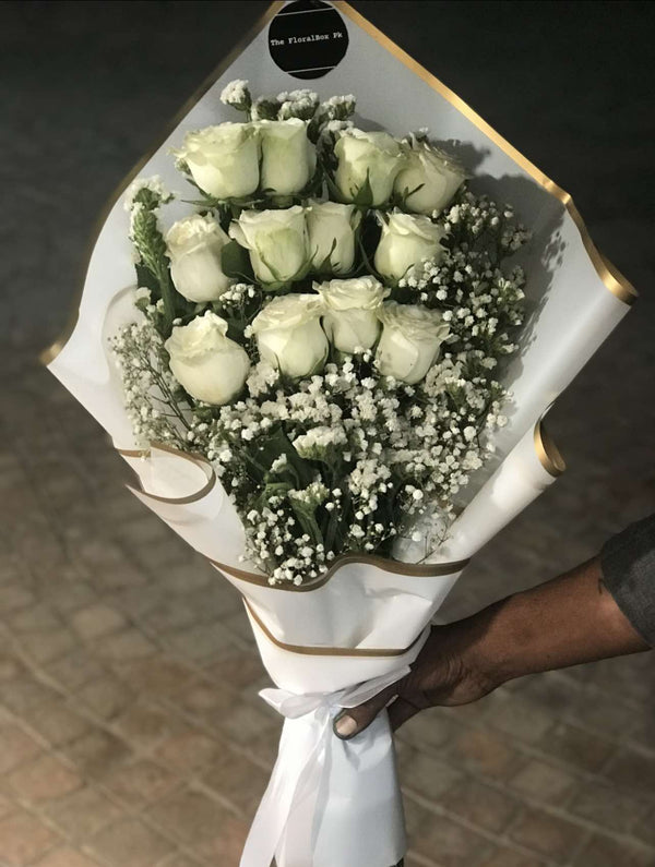 Elegant bouquet of fresh white roses with premium soft-toned wrapping designed as a gift for him